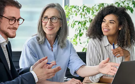 two women and one man in a meeting